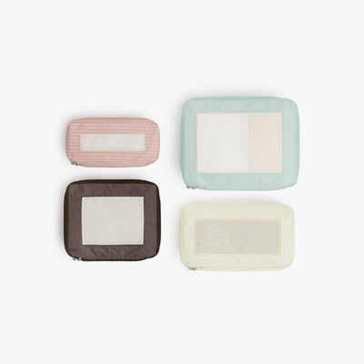 Set of Four / Multi | Top view of Monos x Reformation compressible packing cubes arranged flat to show all sizes in Multi colors