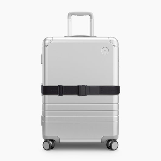 Midnight Black | Front view of Aluminum suitcase with the Midnight Black Luggage Strap secured around it