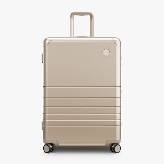 Champagne Gold | Front view of Aluminum Check-In Large in Champagne Gold