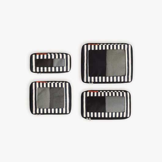 Set of Four / Poplin Stripe Black | Set of four Poplin Stripe Black compressible packing cubes arranged flat to show all sizes